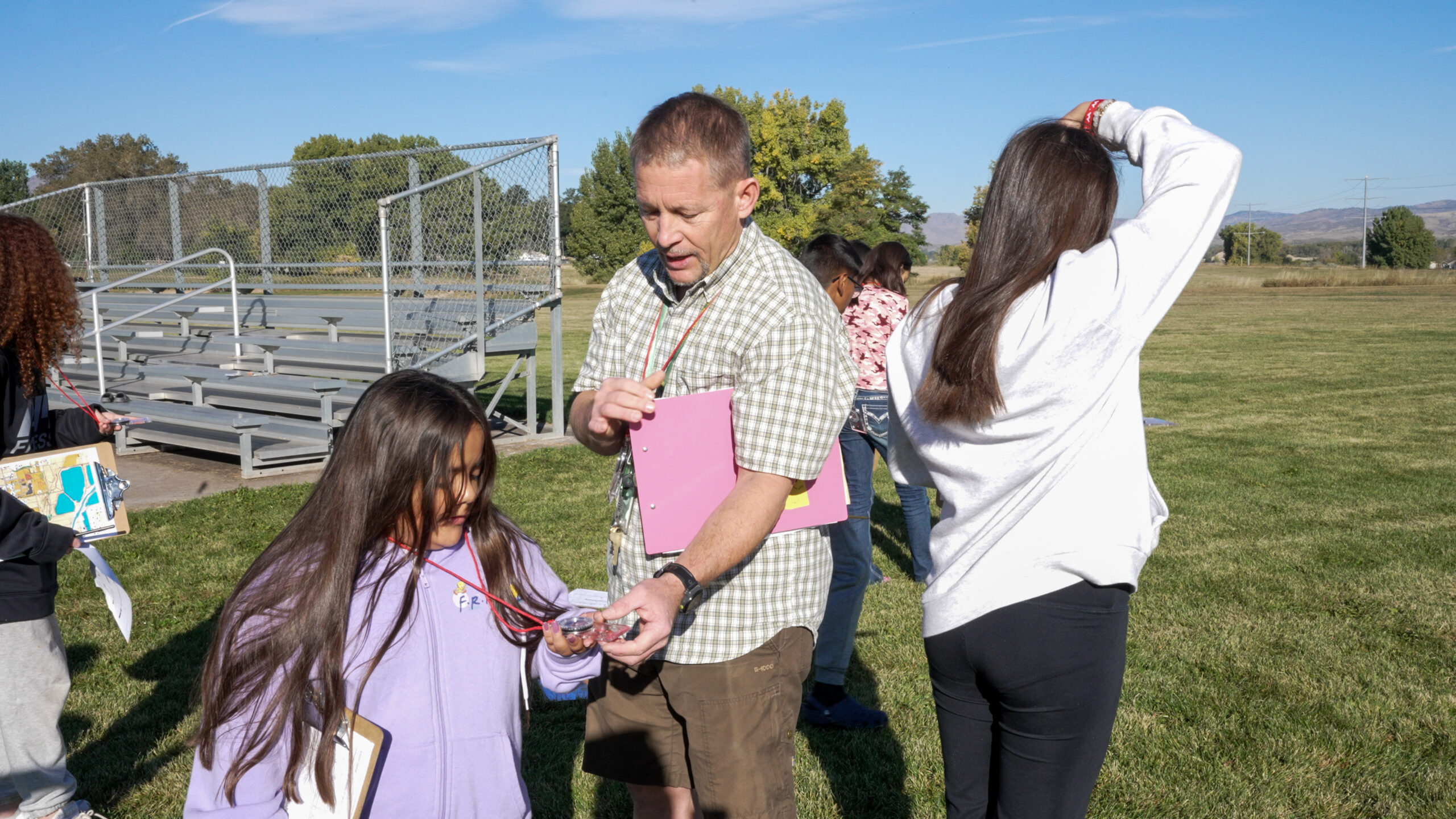 Class learning outdoors using maps and compasses.