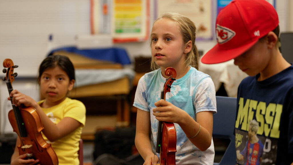 Harris Elementary School students learn string instruments funded by 2023 Impact Grant